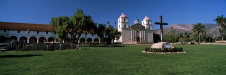 Cross with a church in the background, Mission Santa Barbara, Santa Barbara, California, USA by Panoramic Images art print