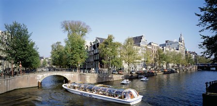 Netherlands, Amsterdam, tour boat in channel by Panoramic Images art print