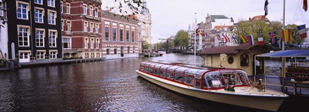 Tourboat in a channel, Amsterdam, Netherlands by Panoramic Images art print