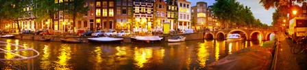 Buildings along a canal at dusk, Amsterdam, Netherlands by Panoramic Images art print