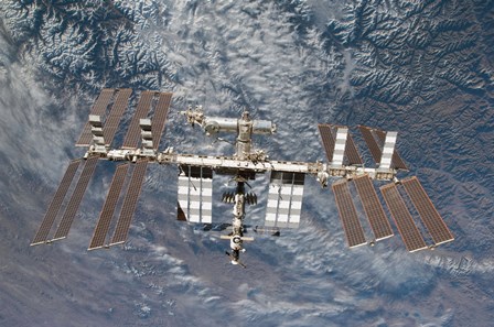 The International Space Station Backdropped by a Rugged Earth Terrain by Stocktrek Images art print