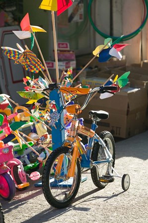 Bicycle Outside Toy Shop, Lesvos, Mytilini, Aegean Islands, Greece by Walter Bibikow / Danita Delimont art print